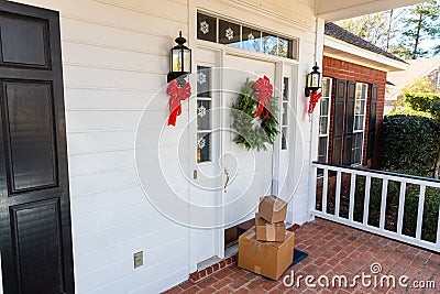 Packages on front porch of home during holiday season Stock Photo