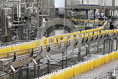 Packed bottles moving on conveyor belt in bottling industry Stock Photo