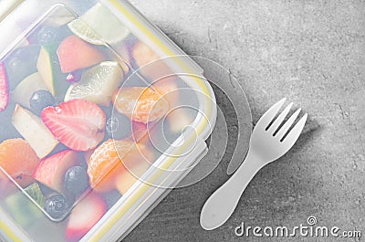 Packed fruit salad in plastic box. Healthy meal to go Stock Photo