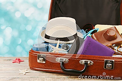 Packed vintage suitcase for summer holidays, vacation, travel and trip. Stock Photo