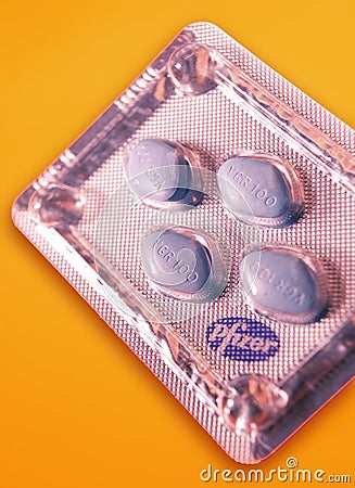 FOUR VIAGRA TABLETS ON YELLOW BACKGROUND Editorial Stock Photo