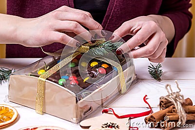 Packing of Christmas cakes. Female hands. Handmade. Christmas decorations. Copy space. Stock Photo