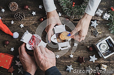 Packing home made cookies and candy canes in Christmas gift boxes Stock Photo