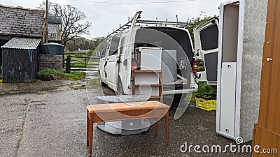 Packing a home removals van truck full of furniture Stock Photo