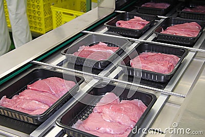 Packing of meat slices in boxes Stock Photo