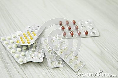 Packs of different pills lie on a white background. Stock Photo