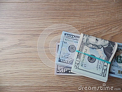 Packs of real dollar banknotes on a wooden table. Thousands dollars of cash. With free space for a text. Stock Photo