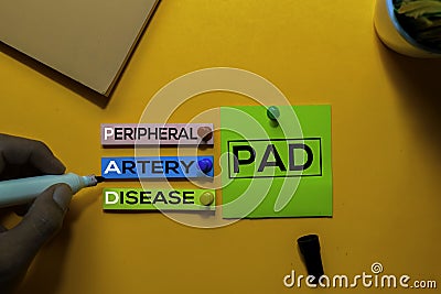 PAD. Peripheral Artery Disease acronym on sticky notes. Office desk background Stock Photo