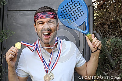 Paddle player holding a bunch of medals Stock Photo