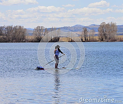 Paddleboarder on a lake in springtime Editorial Stock Photo