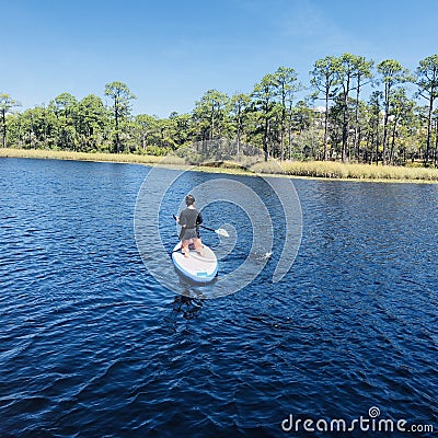 Paddleboarder in WaterColor resort Editorial Stock Photo