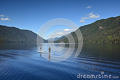 Paddleboarding couple on Lake Crescent in Olympic National Park, Washington. Editorial Stock Photo
