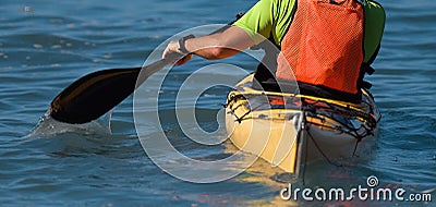 A paddler races his ocean kayak Stock Photo