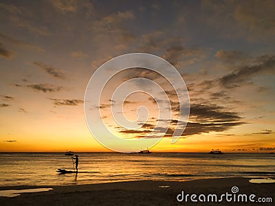 Paddleboarding in Boracay sunset Stock Photo