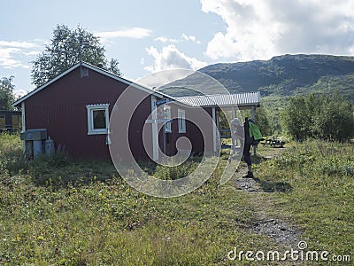 Padjelanta, Norrbotten, Sweden, Agust 14, 2021: Man hiker backapacker in front of STF Sammarlappa Mountain cabin at Editorial Stock Photo