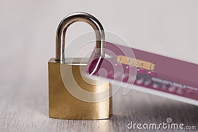 Padlock attached to credit card Stock Photo