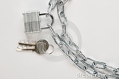 Padlock attached to silver chain. Stock Photo