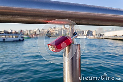 Padlock hanged on bridge iron railing Stock Photo