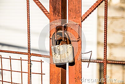 A padlock of the old style on the gate. Stock Photo