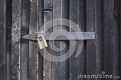 Padlock on a wooden wall. On wooden gates. Stock Photo