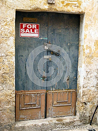 Padlocked Blue and Tan Door to a House for Sale Editorial Stock Photo