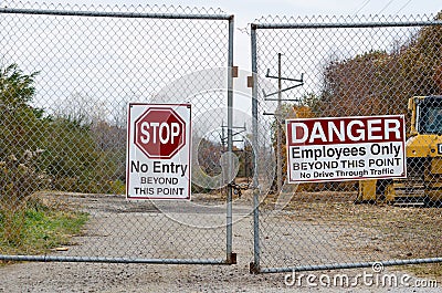 Locked gate and signs Stock Photo