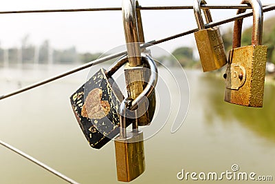 Padlock with love writings on bridge Stock Photo