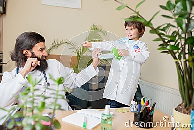 Paediatrician doctor examining a child in comfortabe medical office Stock Photo