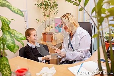 Paediatrician doctor examining a child in comfortabe medical office Stock Photo