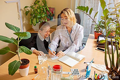 Paediatrician doctor examining a child in comfortabe medical office Stock Photo