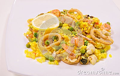 Paella with chicken and seafood, white background Stock Photo