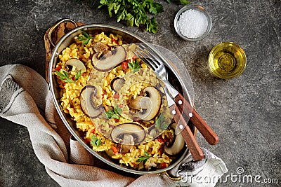 Paella or risotto with mushrooms, bell peppers, carrots, onions, white wine and olive oil. Homemade healthy food. Stock Photo