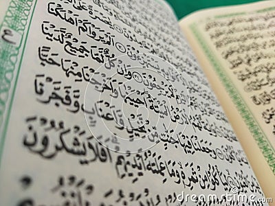 page on the contents of the Koran with Arabic writing with a blur effect Stock Photo