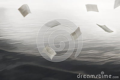 Pages of a book dance sweetly above the waves of the sea Stock Photo