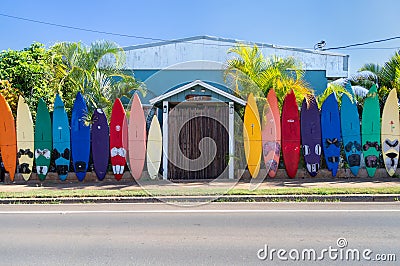 PAIA, HI - NOVEMBER 15 2019: Colorful Rainbow of surfboards line the outside of the Aloha Surf Hostel in Paia, Maui, HI Editorial Stock Photo