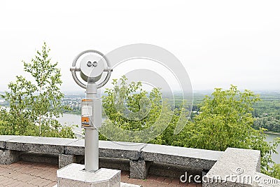 Paid binoculars for exploring the city close-up. Observation deck for exploring the city. Silver telescope with city view Stock Photo