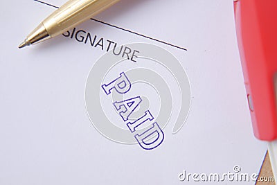 Paid invoice and Rubber Stamp on paper , Stock Photo