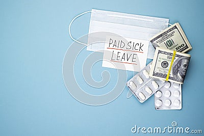 Paid sick leave with a medical mask and money on a blue background Stock Photo