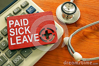 Paid sick leave words on the red plate. Stock Photo