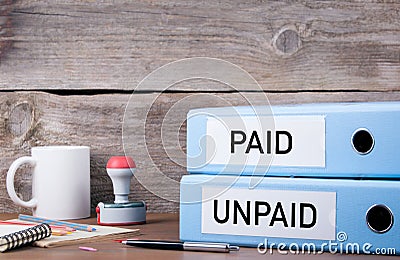 Paid and Unpaid. Two binders on desk in the office. Business background Stock Photo