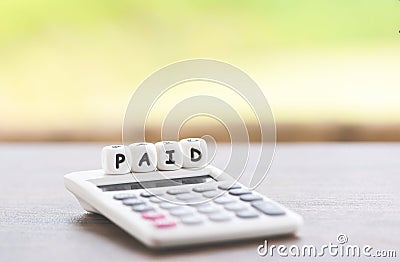Paid words and calculator on table for time paid payment at office business Stock Photo