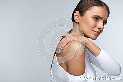 Pain In Body. Beautiful Woman Feeling Pain In Neck And Shoulders Stock Photo