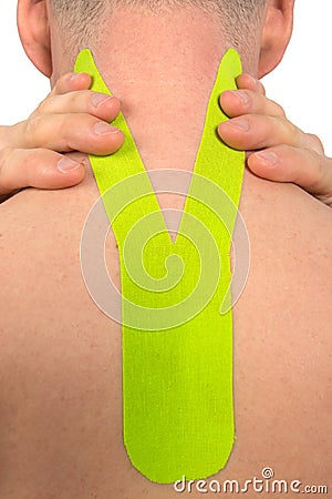 For pain in the cervical vertebrae and trapezoidal muscle, the athlete pasted a fixing tape to relieve spasms, close-up Stock Photo