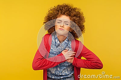 Pain in chest. Portrait of young depressed woman frowning and touching breast, risk of cancer, feeling acute heart ache Stock Photo