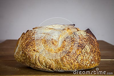 Loafs or miche of French sourdough, called as well as Pain de campagne, on display on a wooden table. Stock Photo