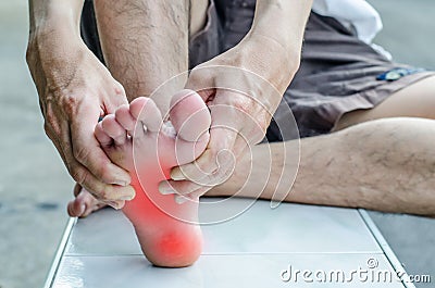 Pain in the foot. Massage of male feet. Stock Photo