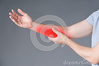 Pain in forearm, muscle inflammation, studio shot on gray background Stock Photo