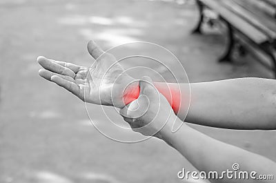 Pain in a man wrist. Male holding hand to spot of wrist pain Stock Photo