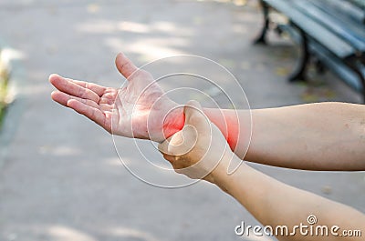 Pain in a man wrist. Male holding hand to spot of wrist pain in Stock Photo