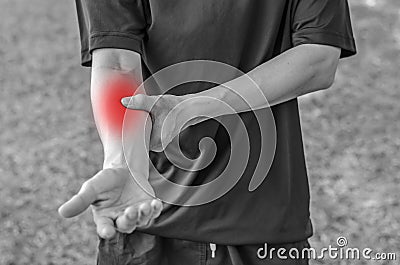 Pain in a man wrist. Male holding hand to spot of wrist pain Stock Photo